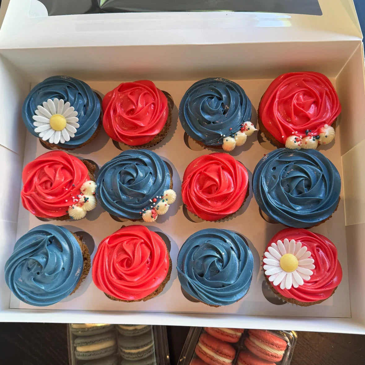 Box of cupcakes with red, white, and blue frosting