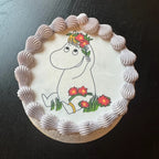 Decorative cake with a cartoon character holding flowers on a dark background