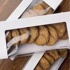 Cookies in a white box on a wooden surface