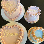 Four decorated cakes with personalized text on a dark surface